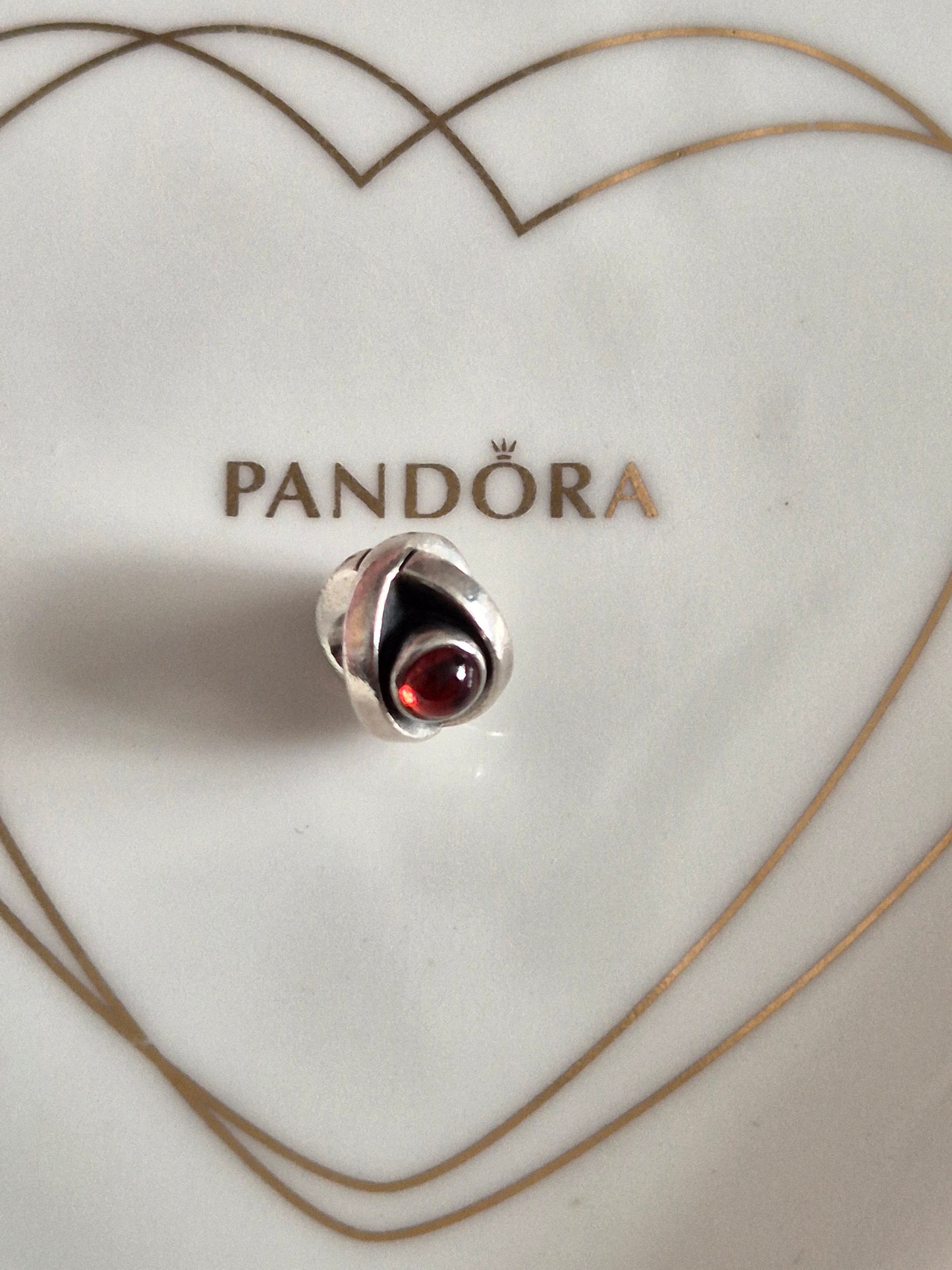 Pandora garnet eye charm